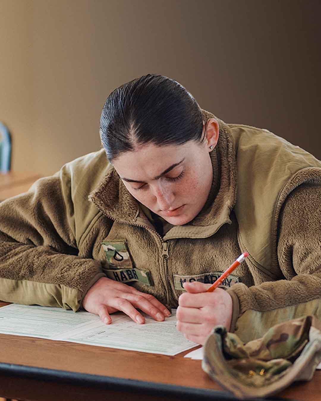 PFC Noor Habr writing in a note book