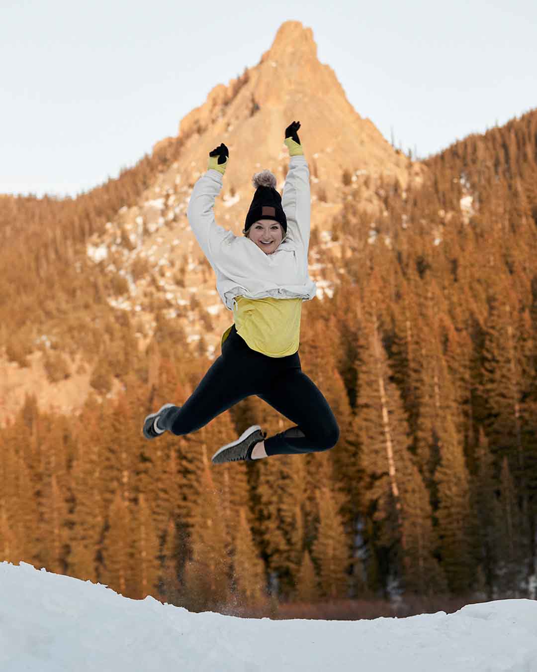 Captain Shaelyn Layton jumps and poses in snow
