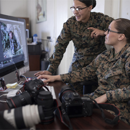 Brooke looking at computer with a friend