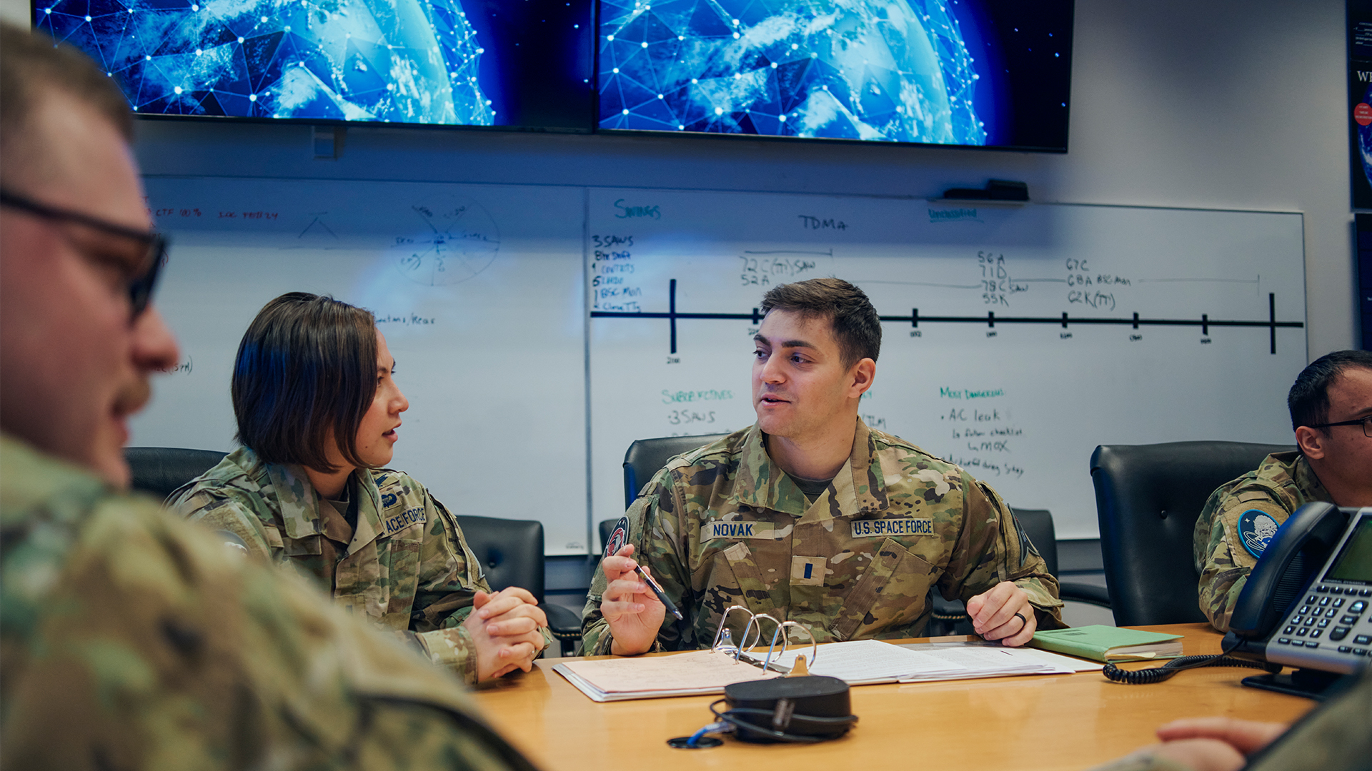 Jon Novak chatting with a colleague