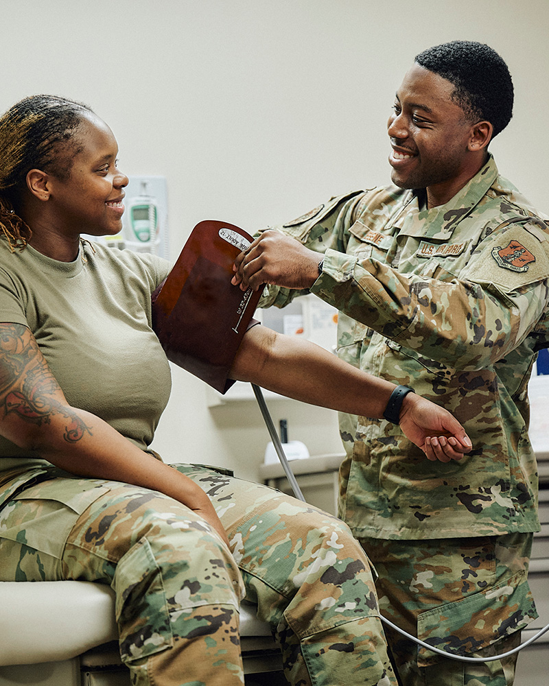 Isaac Esene taking a service members blood pressure