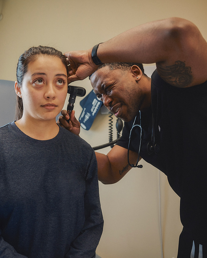 Isaac Esene performing an ear exam