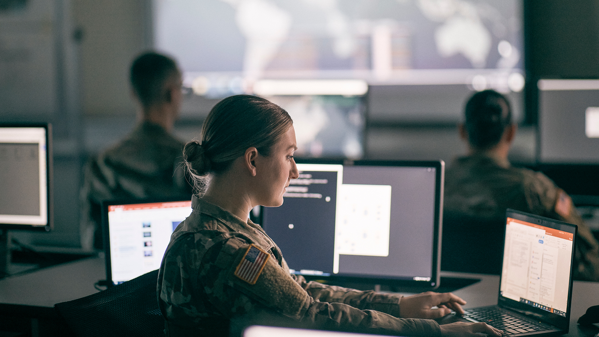 Shaelyn Layton working on multiple screens behind a desk