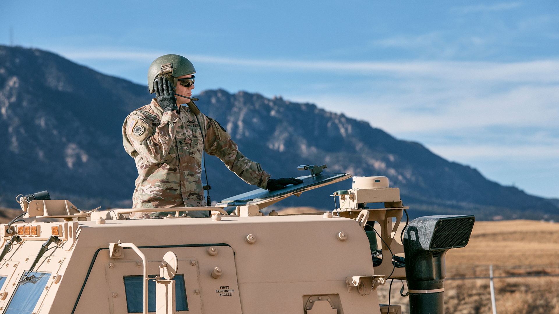 Philip Jeffries out of the top of a humvee