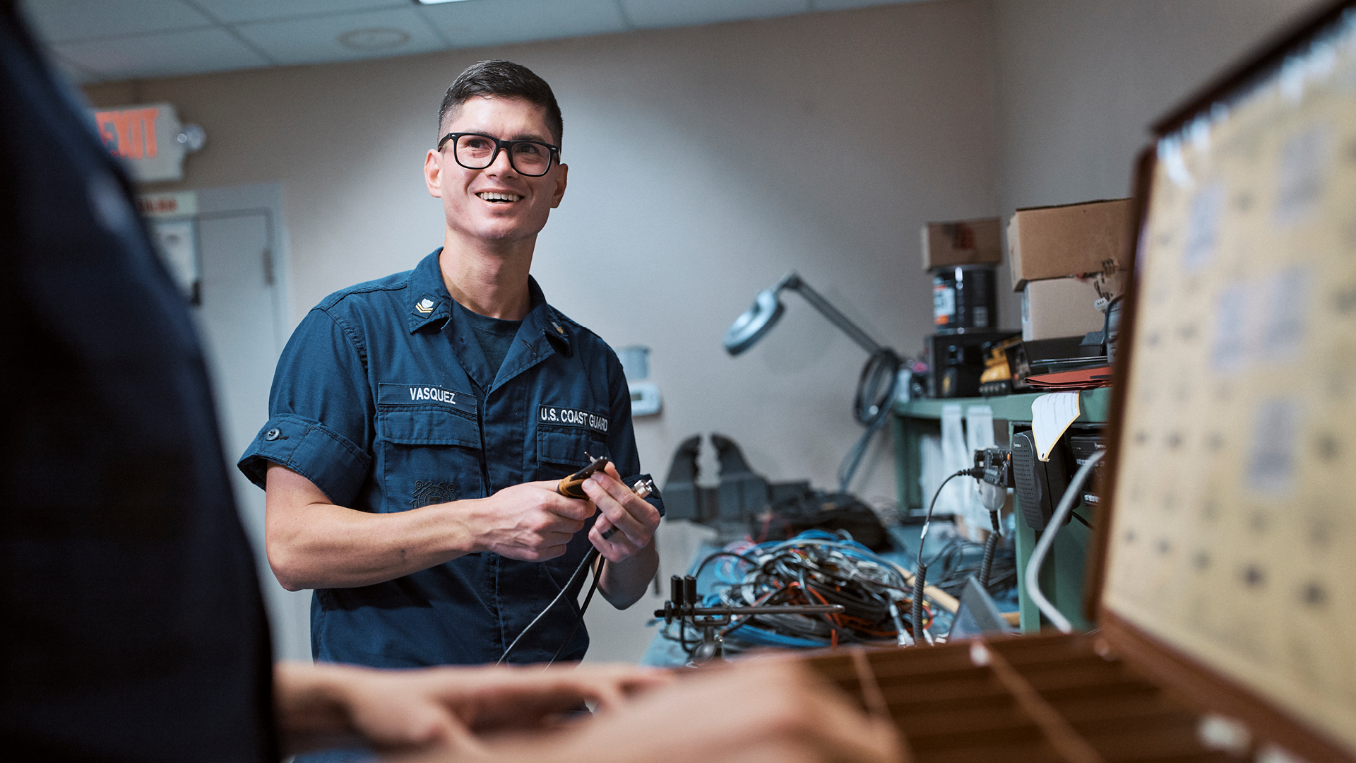 Adrian Vaszquez chatting with a coworker