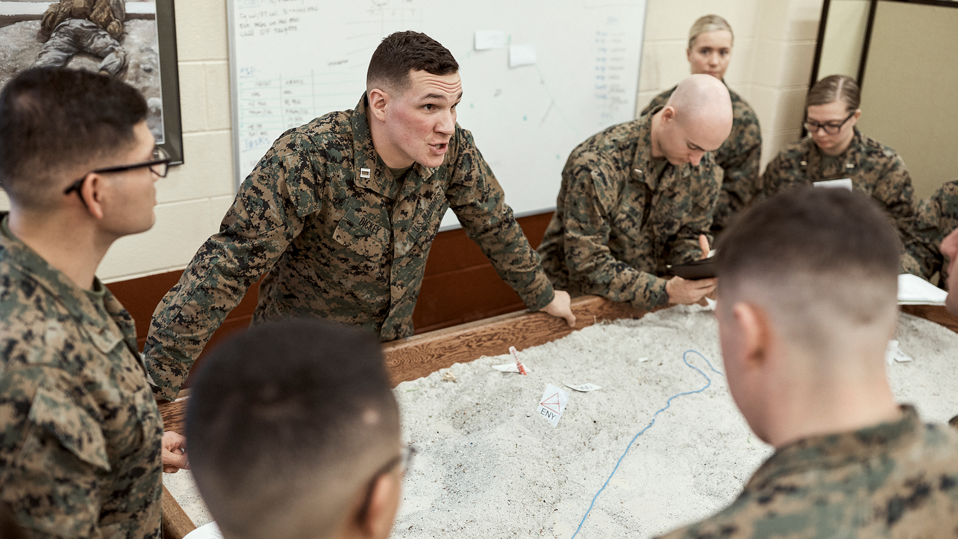 Austin Dickey standing over a sandbox