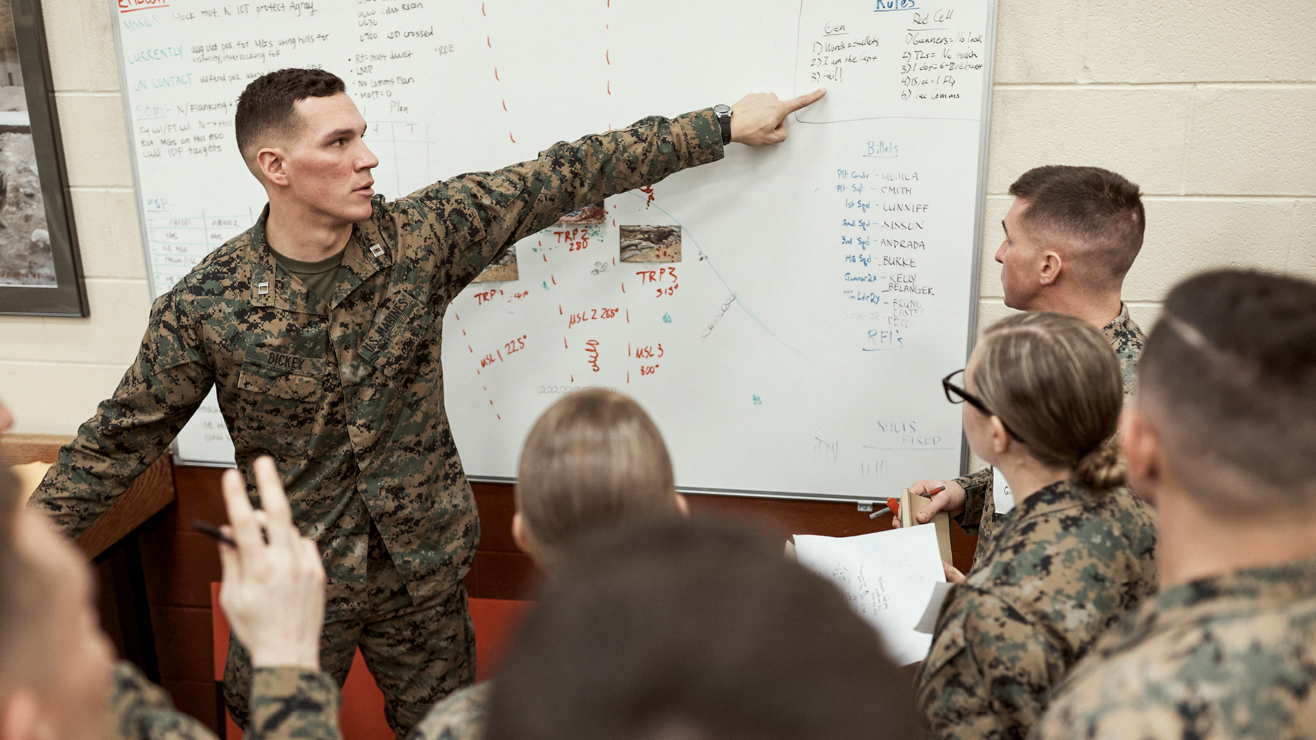 Austin Dickey pointing to a whiteboard