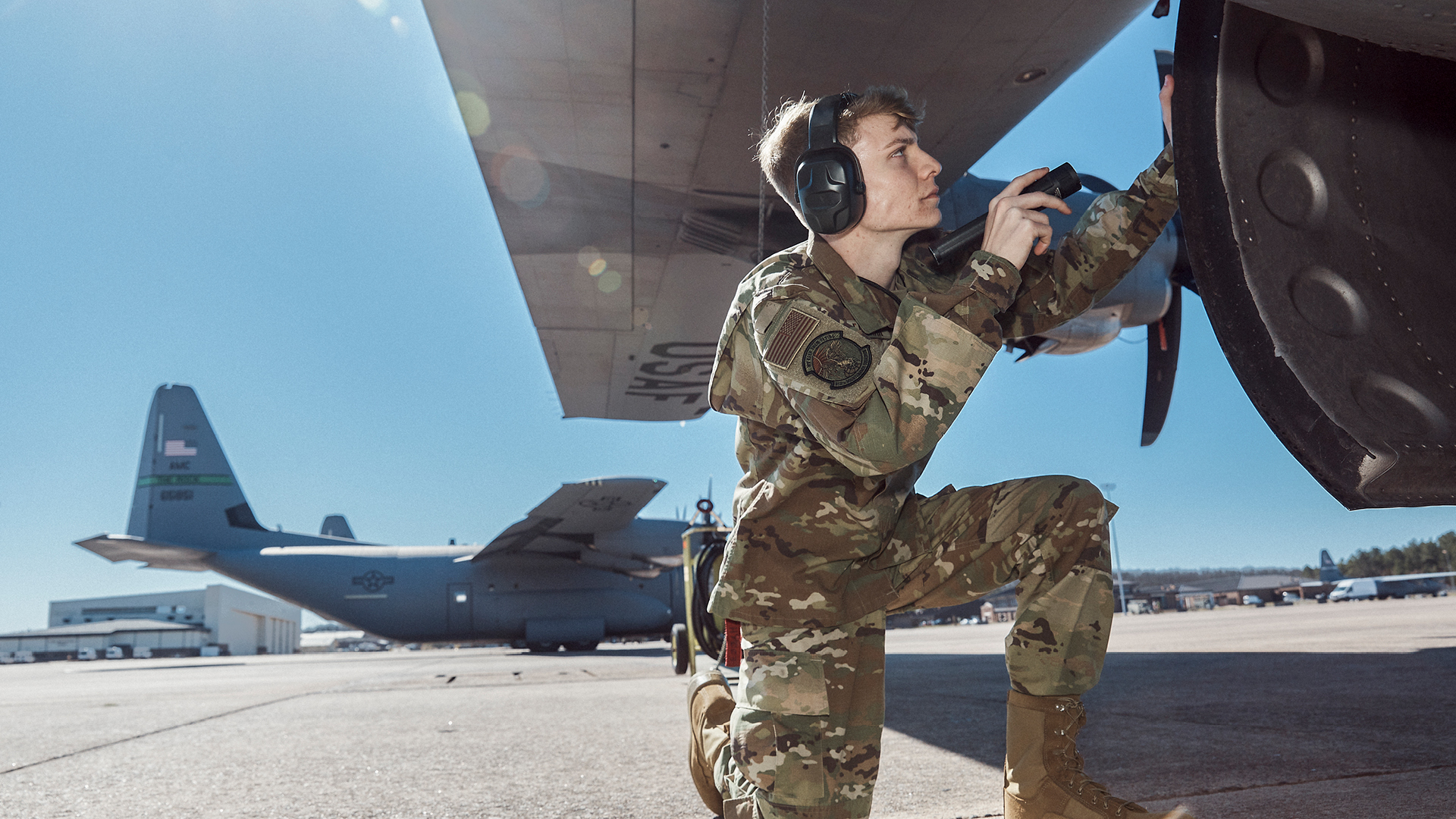 Aircraft Mechanic Corbin Farrar working on a plane 