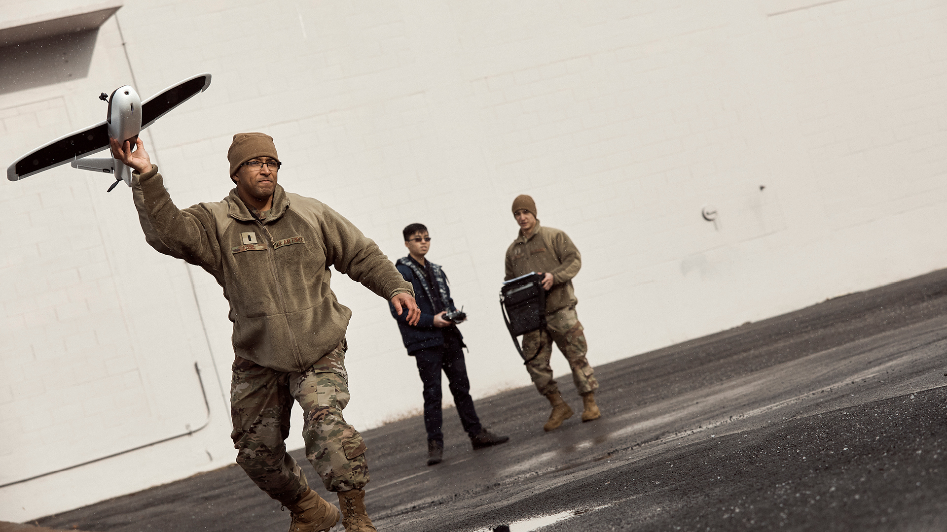 Phillip Lane throwing a miniature airplane