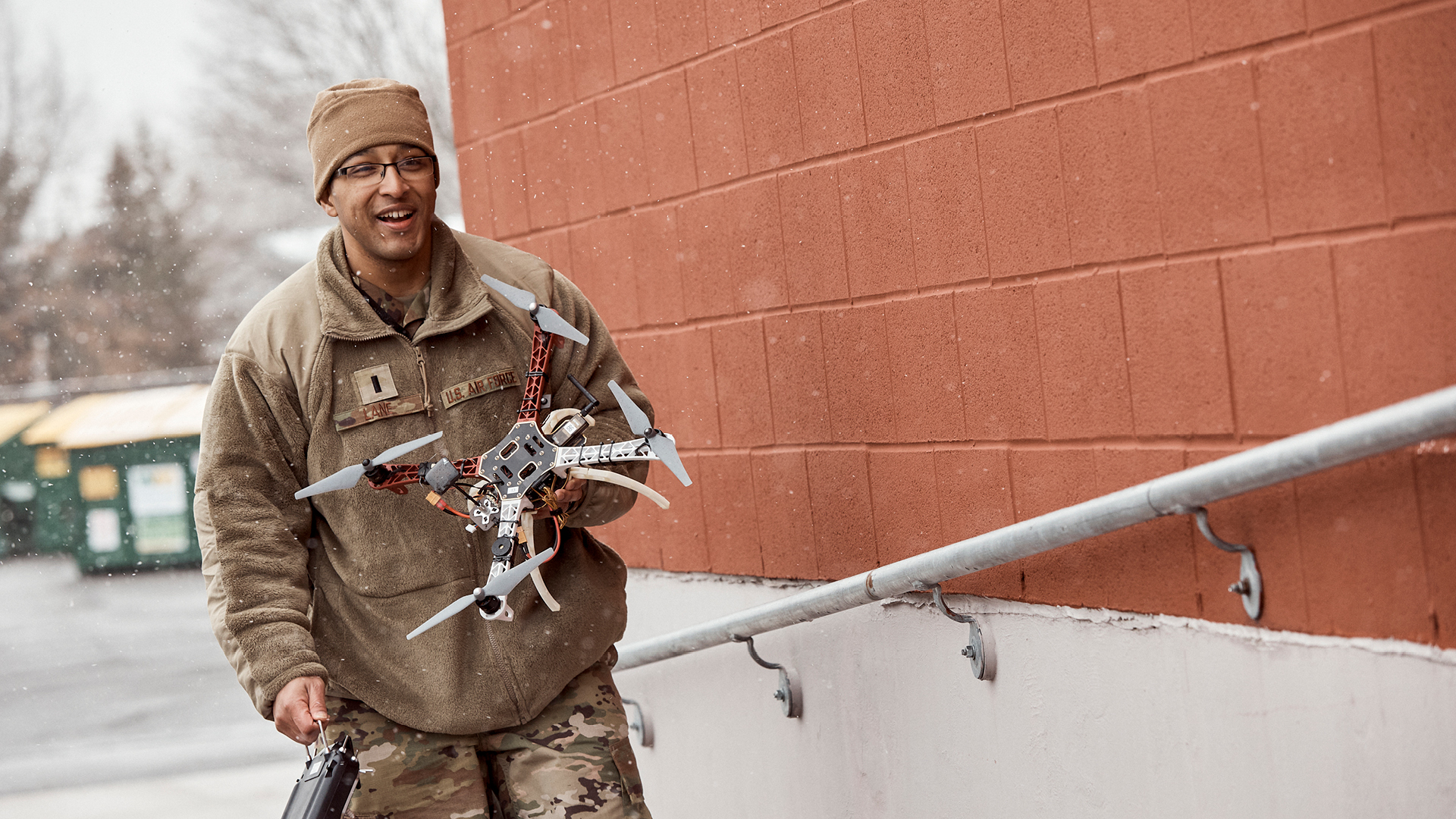 Phillip Lane walking up a ramp with a drone in his hand