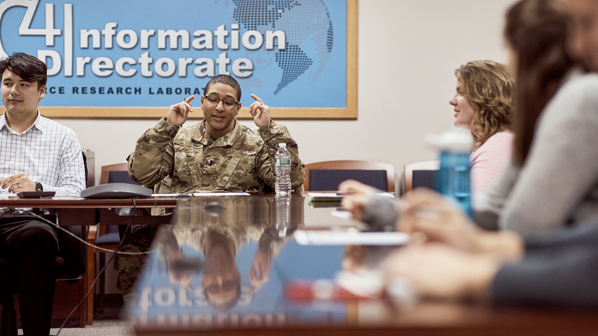 Phillip Lane talking to his team at the meeting table