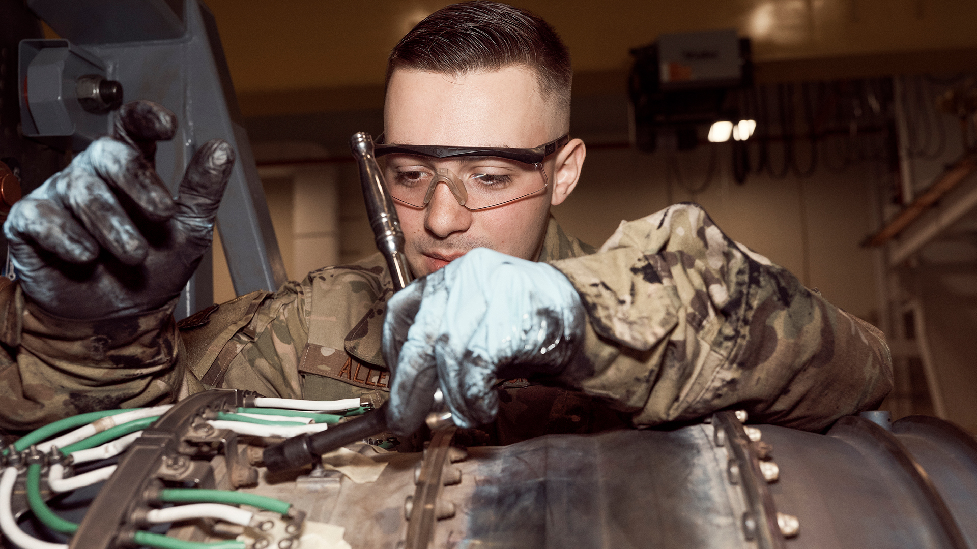 Jacob Allen working on a plane engine