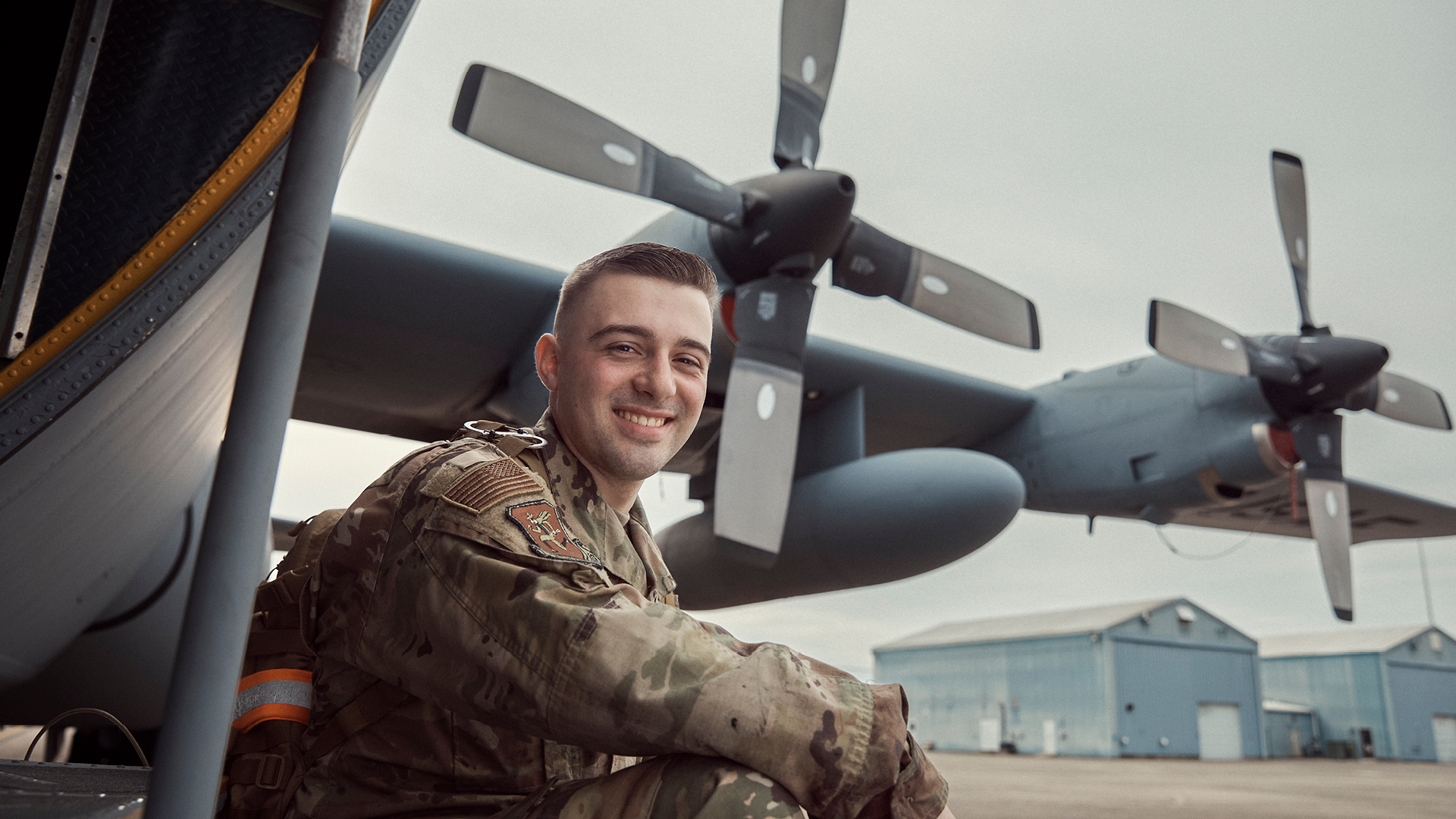 Jacob Allen smiling under a plane