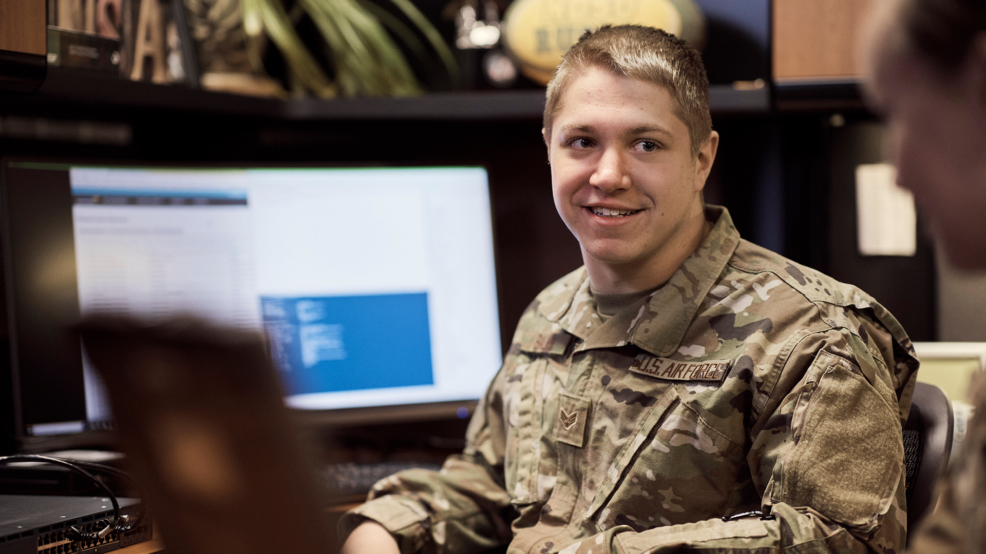 Logan Balvik smiling at a coworker