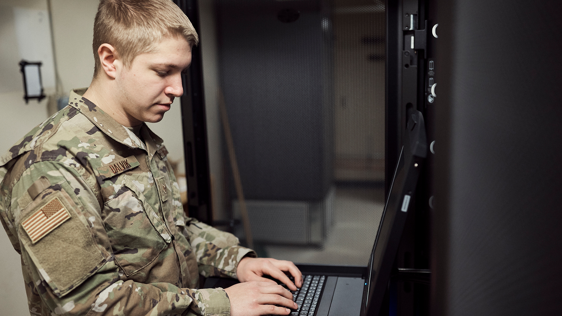 Logan Balvik working on a computer server