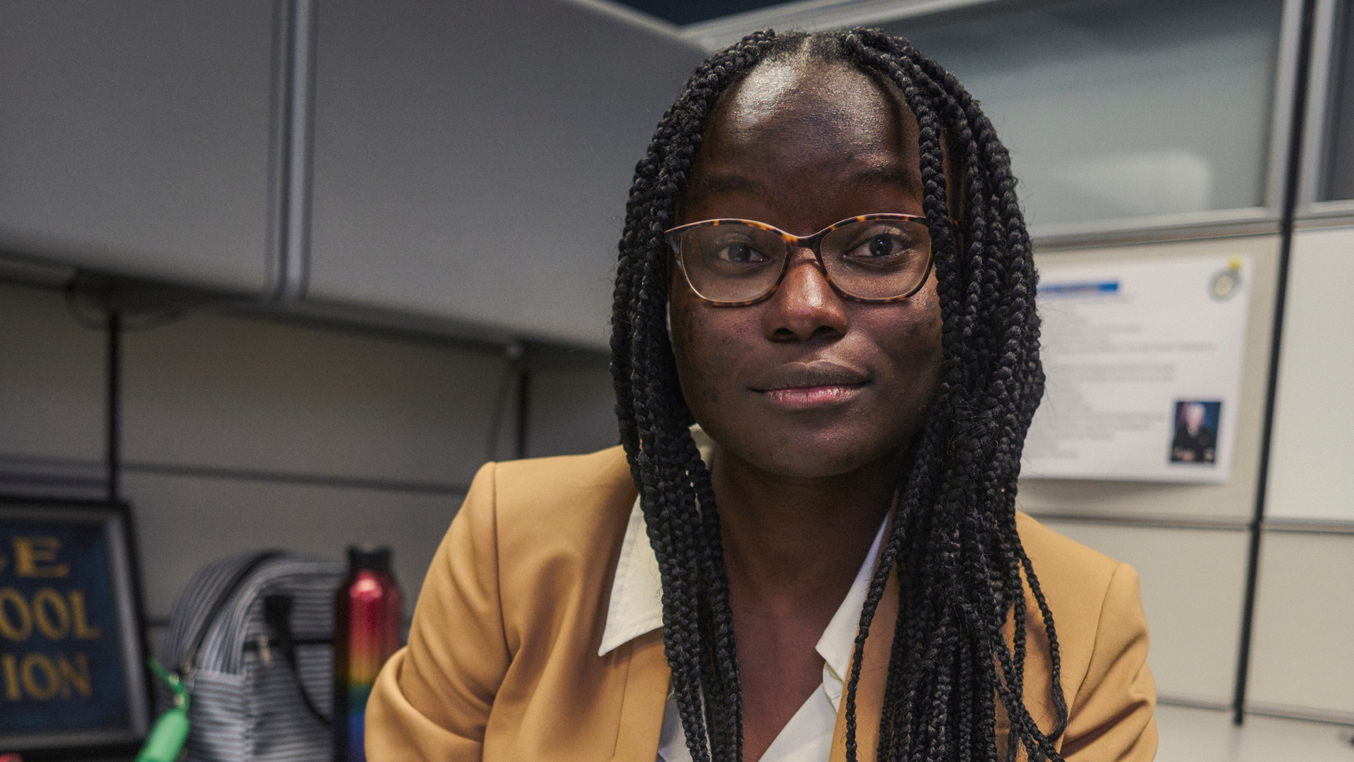 Tyra Newton sitting at a desk looking at the camera