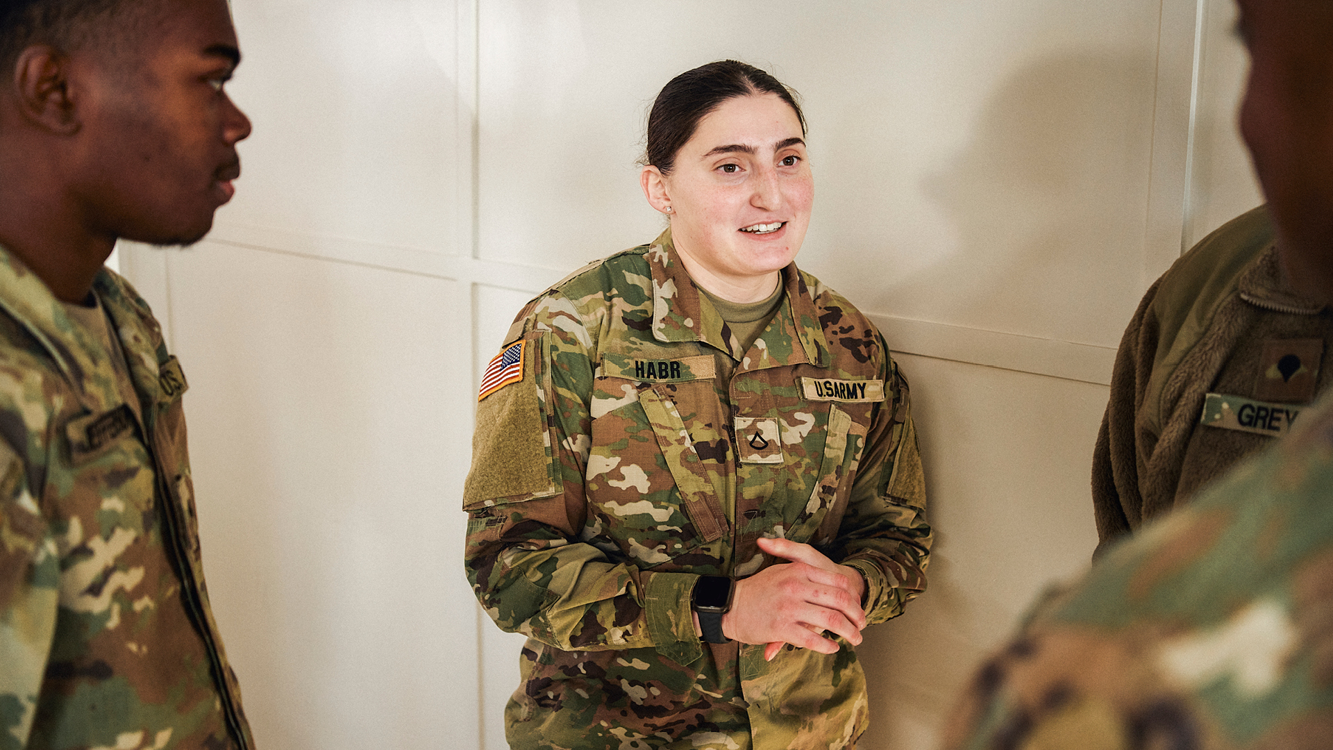 Noor Habr talking with other service members