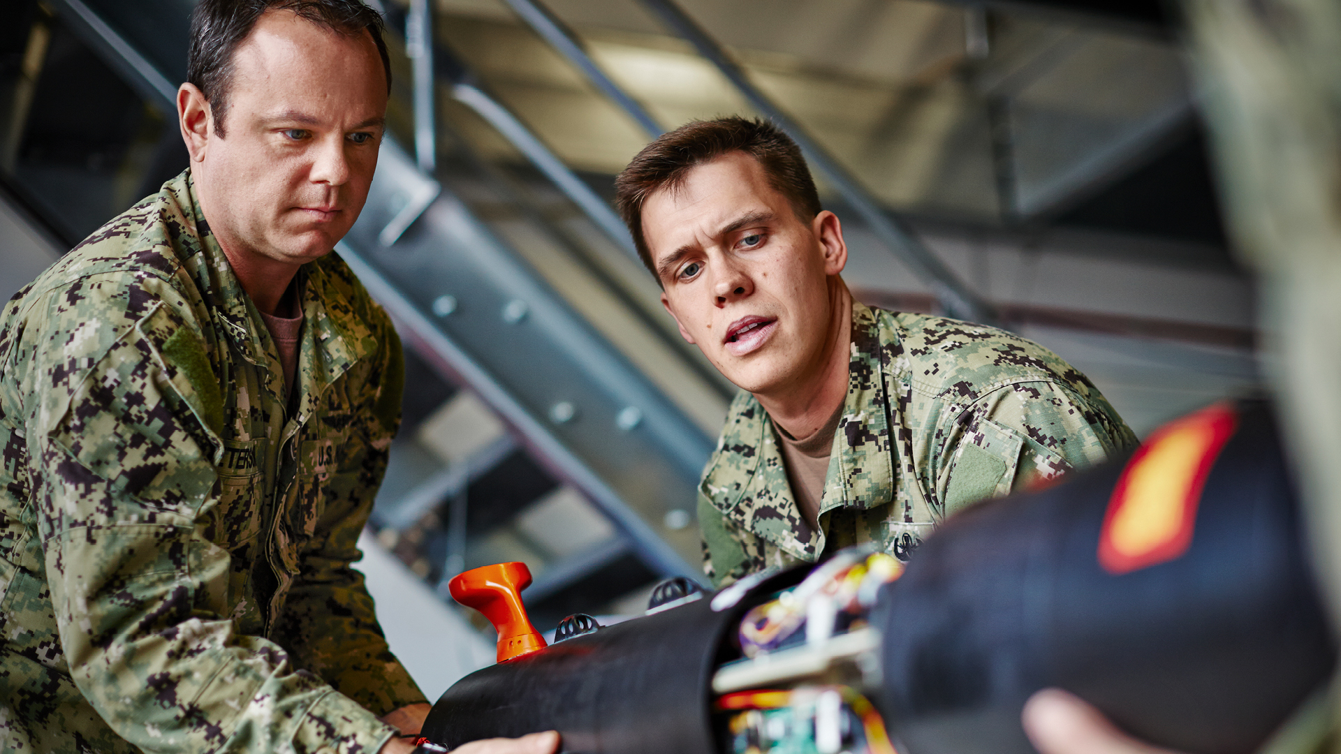 Alex and a coworker working on an explosive device