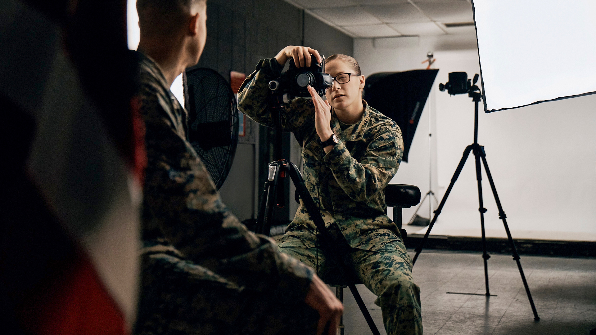 Brooke using her camera to take a photo of a service member