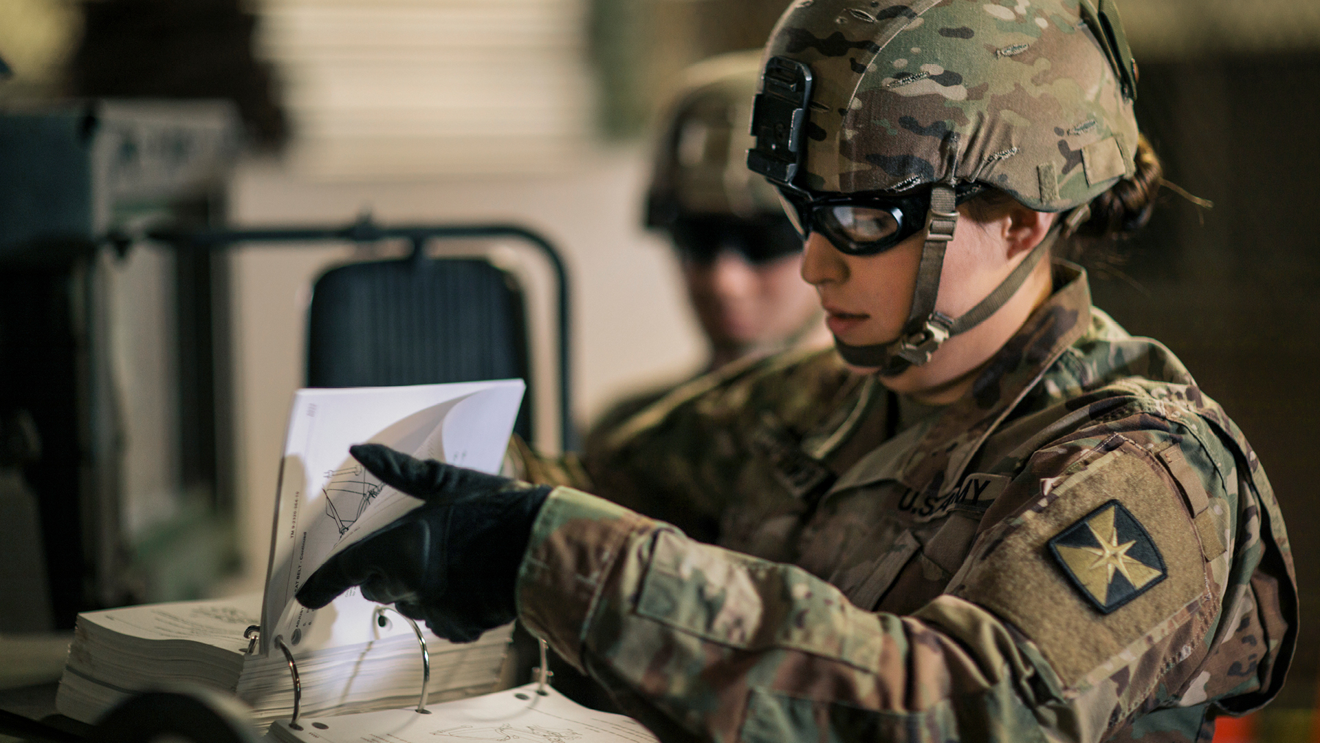 Littlewolf and a coworker looking at a document 