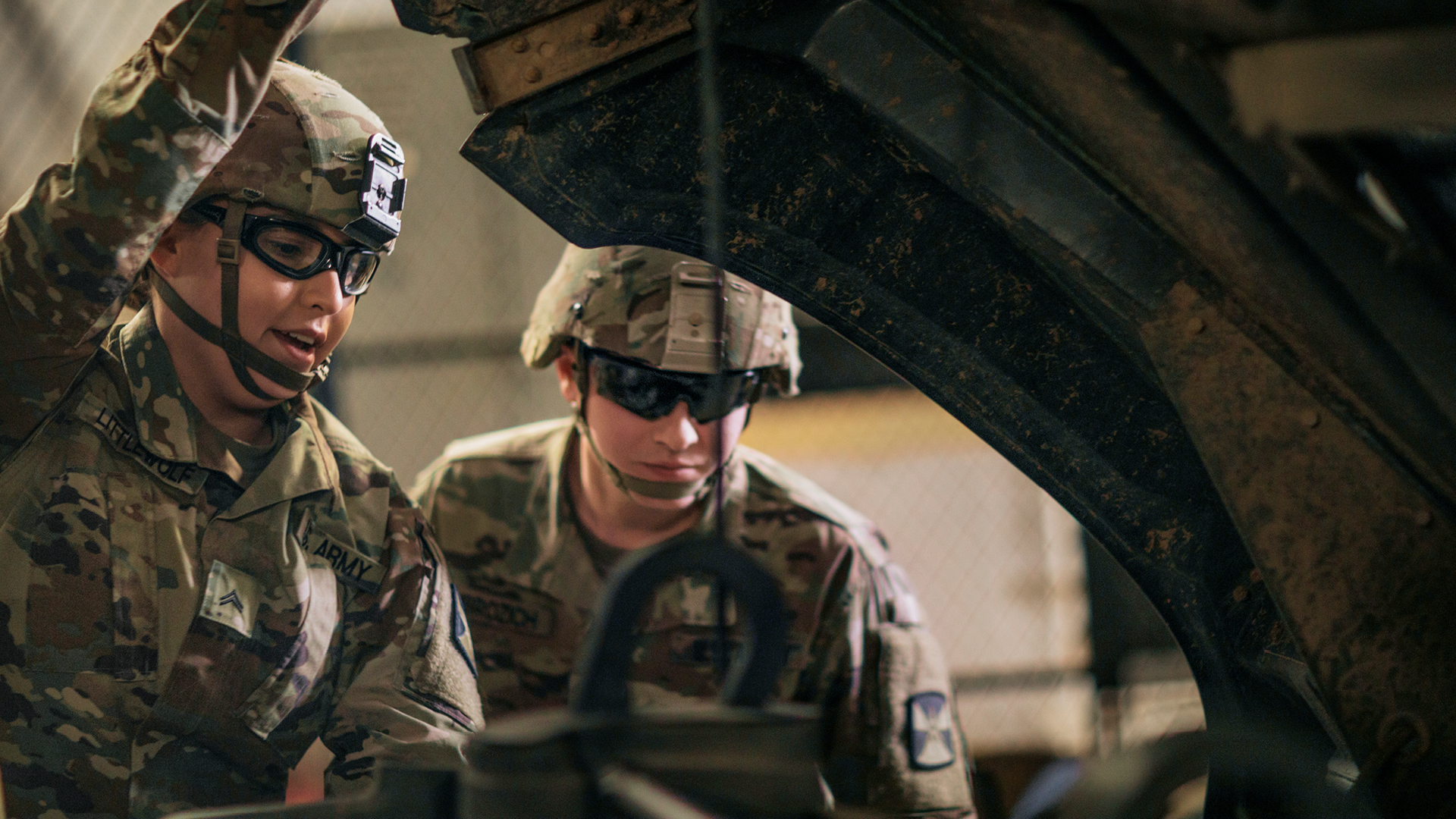 Littlewolf and a coworker working on a truck