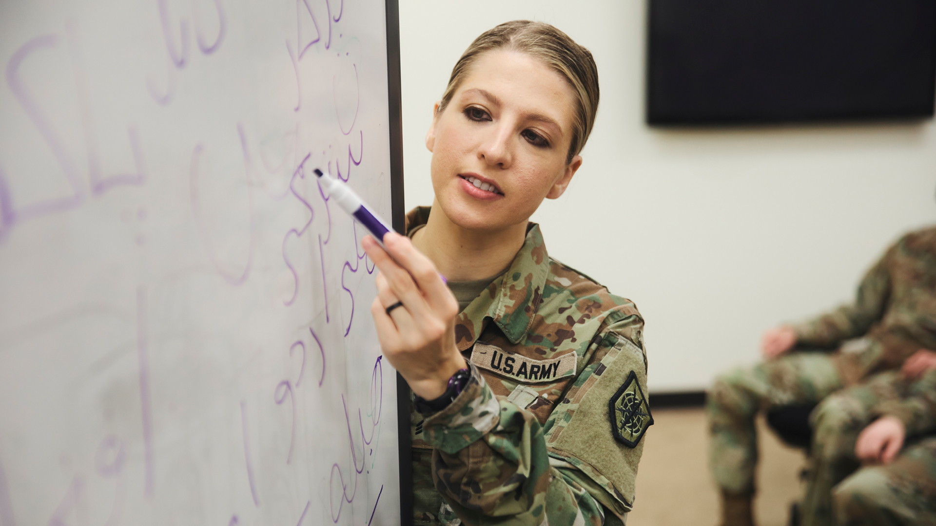 Emily Dowdell teaching using a whiteboard 