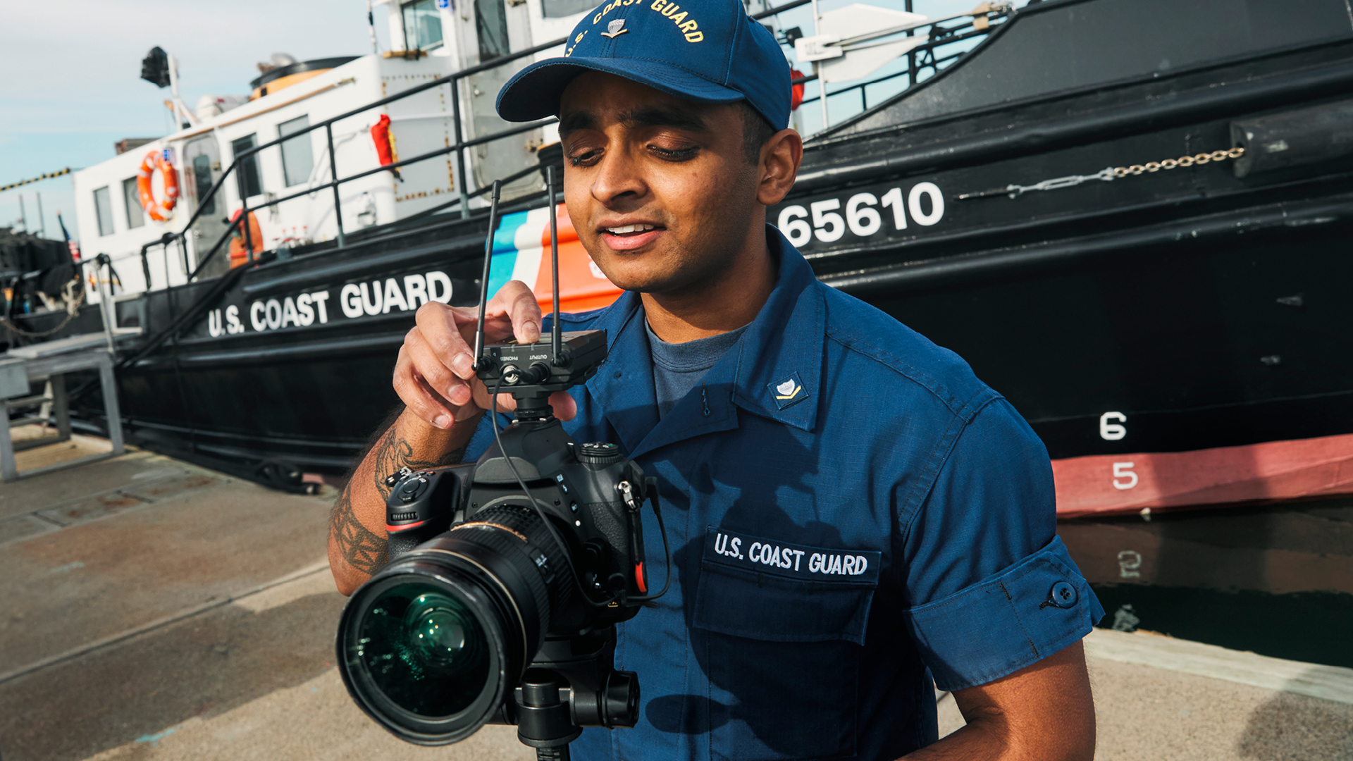 Anthony reviewing photos he took on a camera