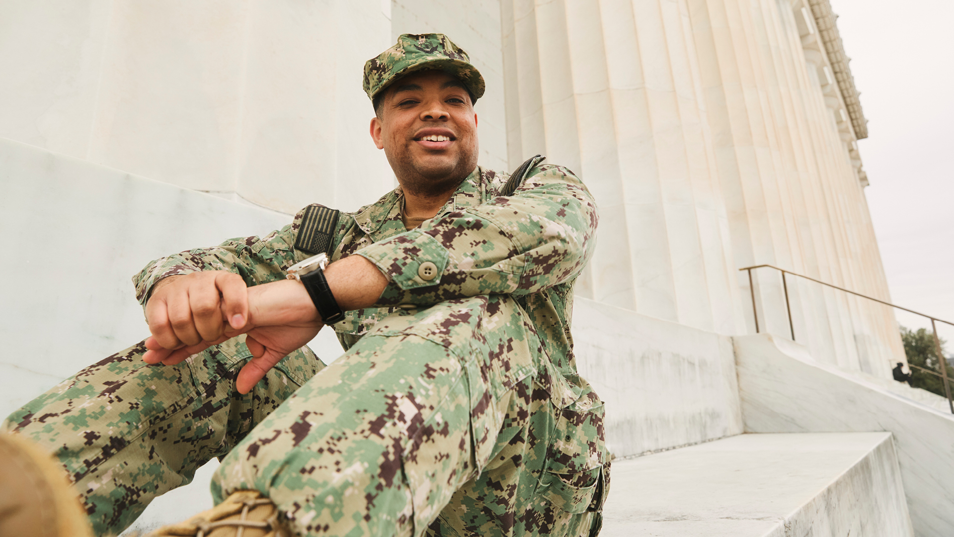 Dominique sitting on the steps in full uniform