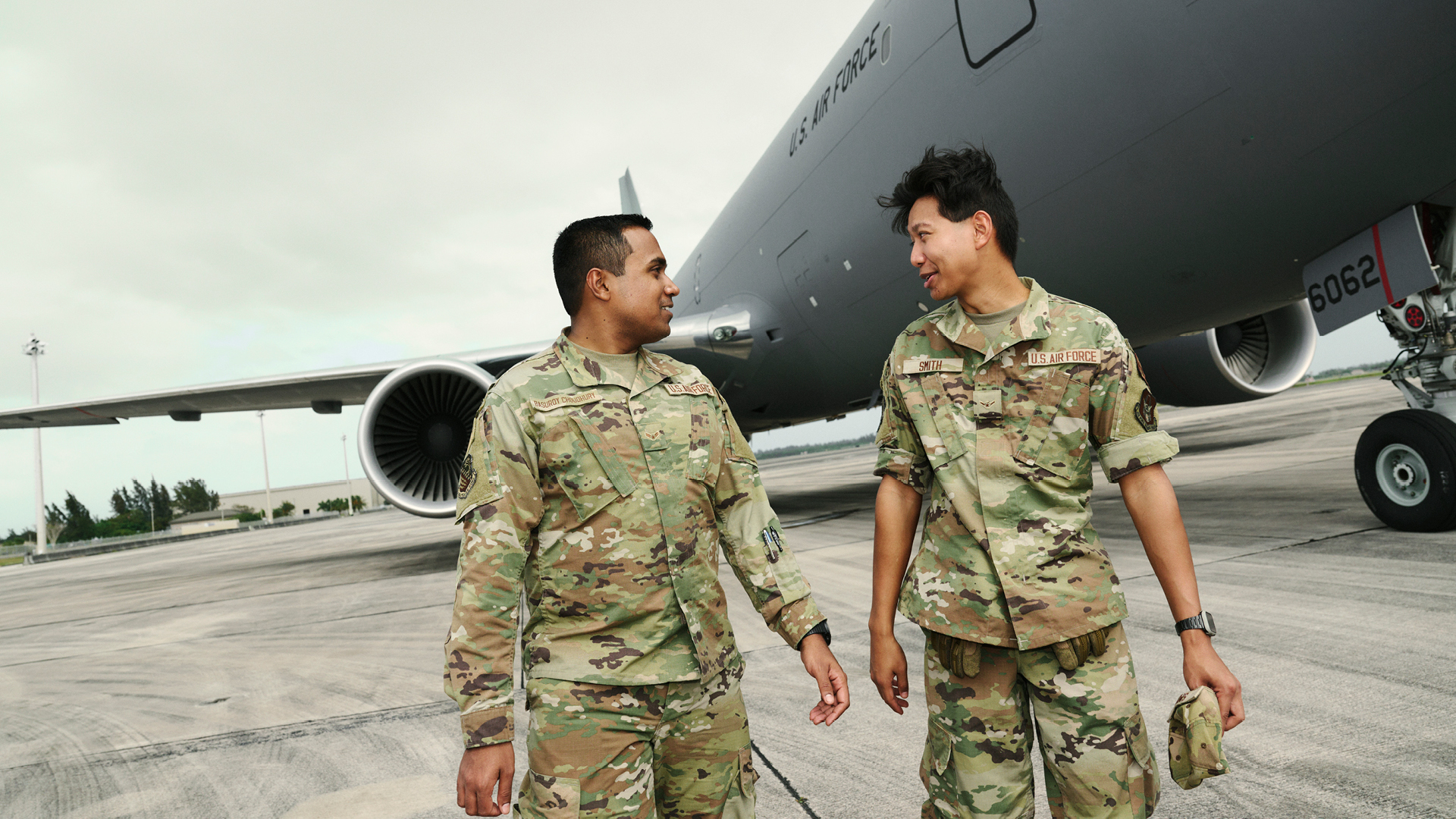 Sourav Choudhury and a coworker talking outside on the tarmac