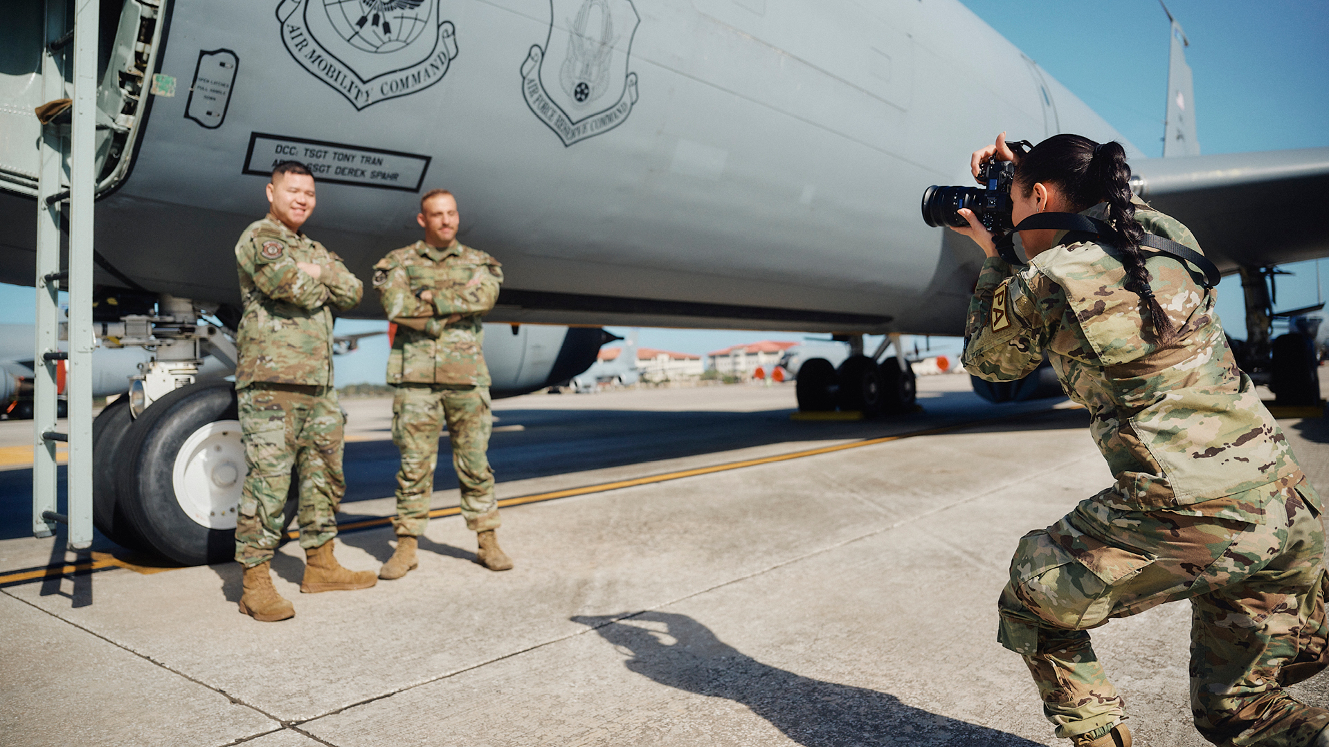 Alexis Suarez taking a photo of service members