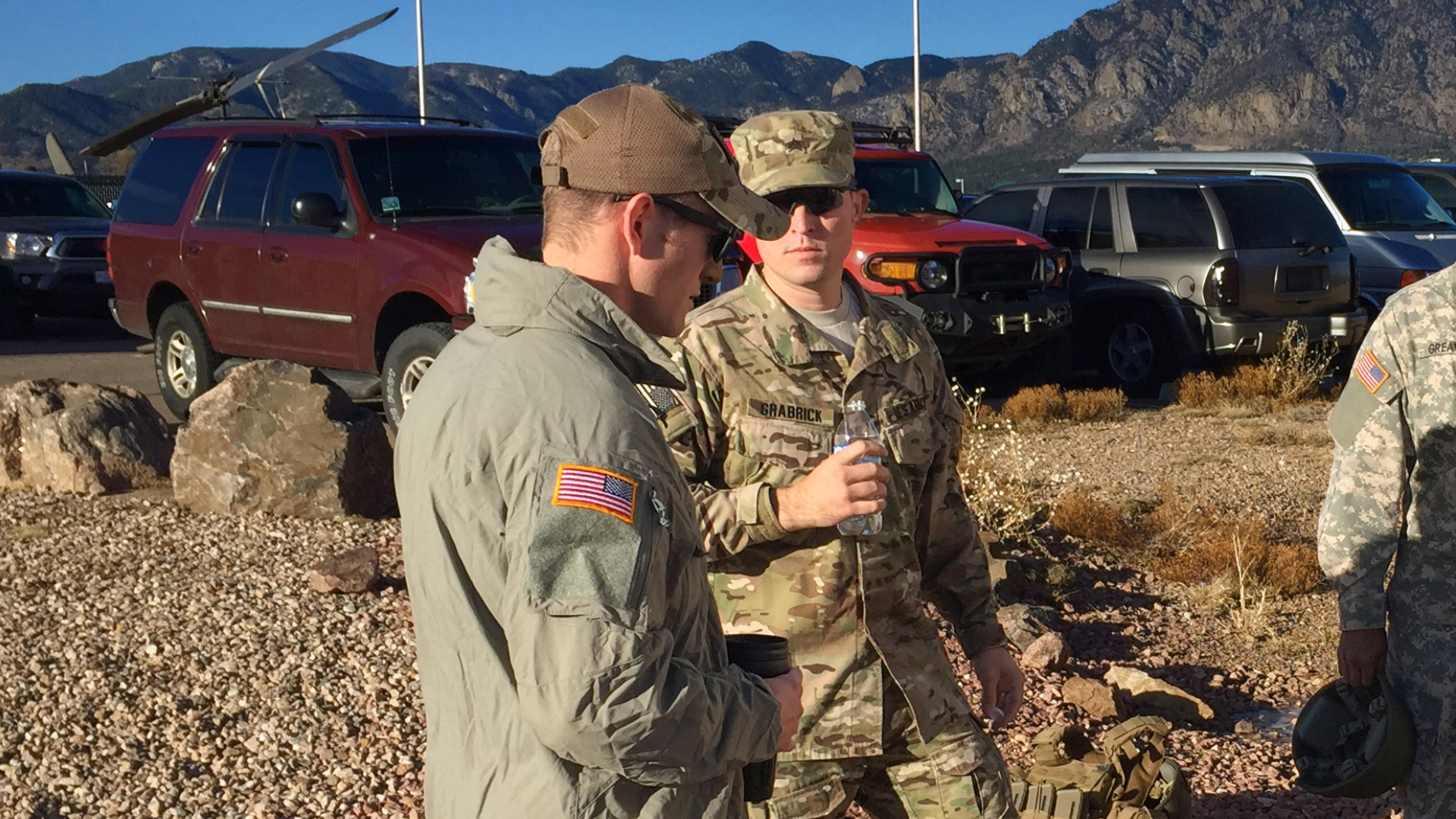 Hunter talking with other service members outside