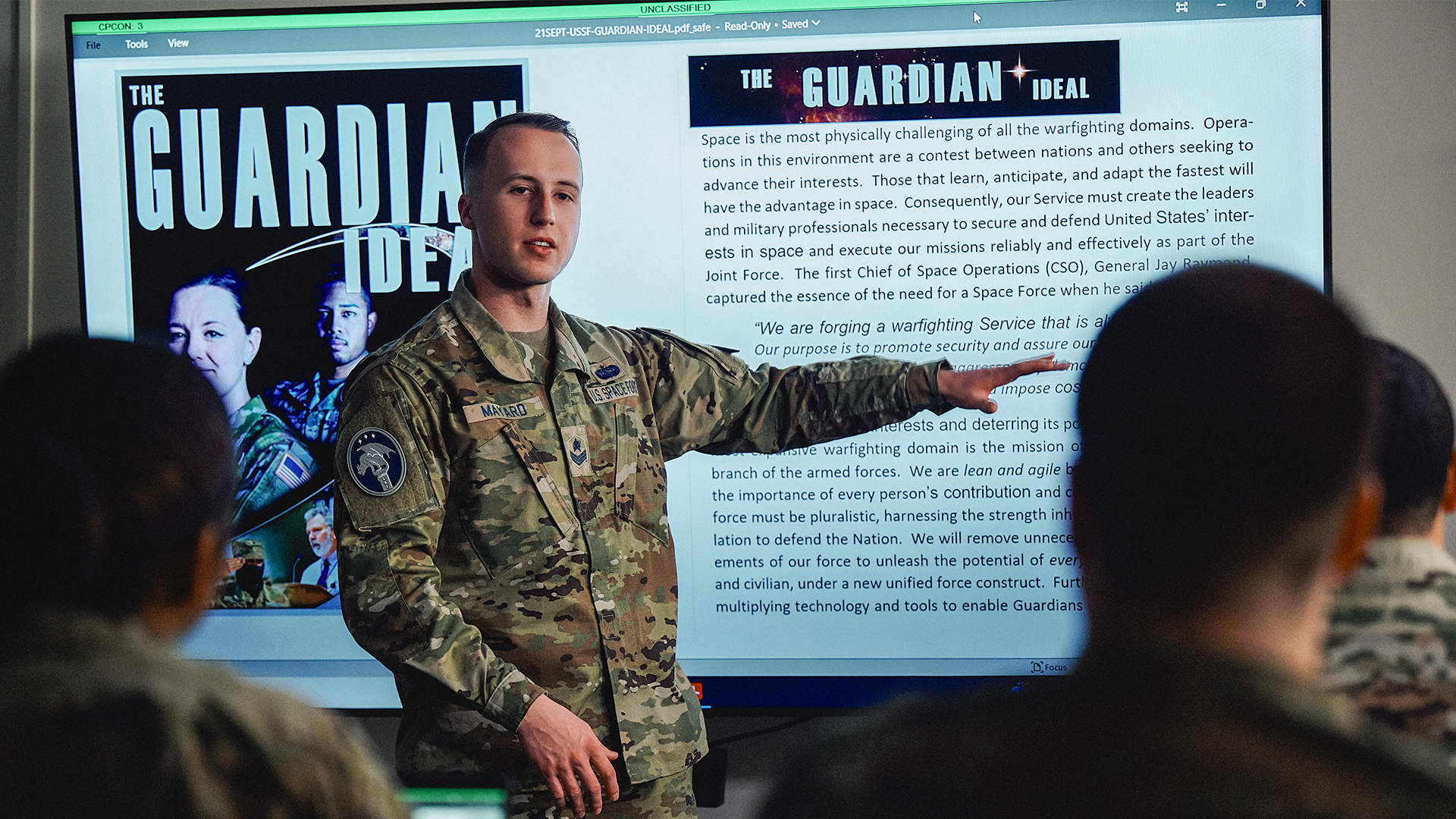 Isaac Mayard giving a presentation in front of a monitor