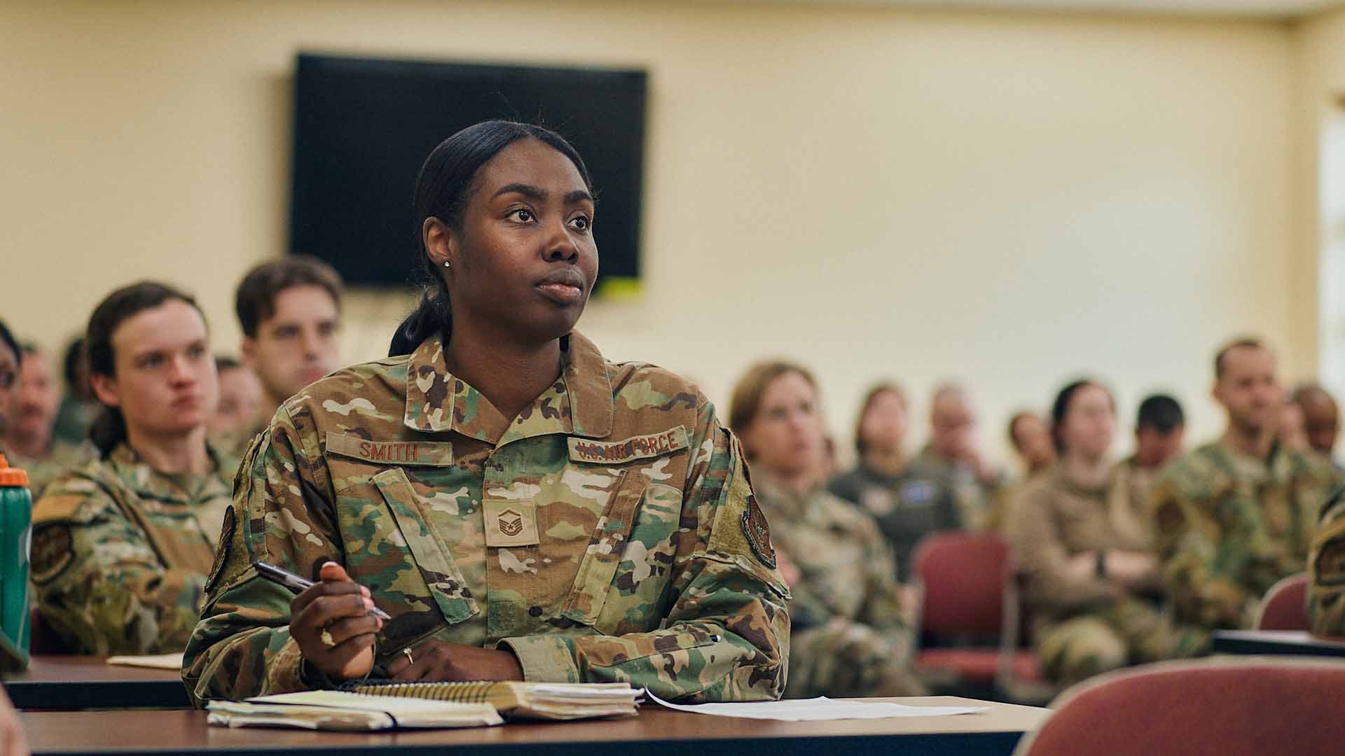 Shakeyna Smith taking notes in a classroom