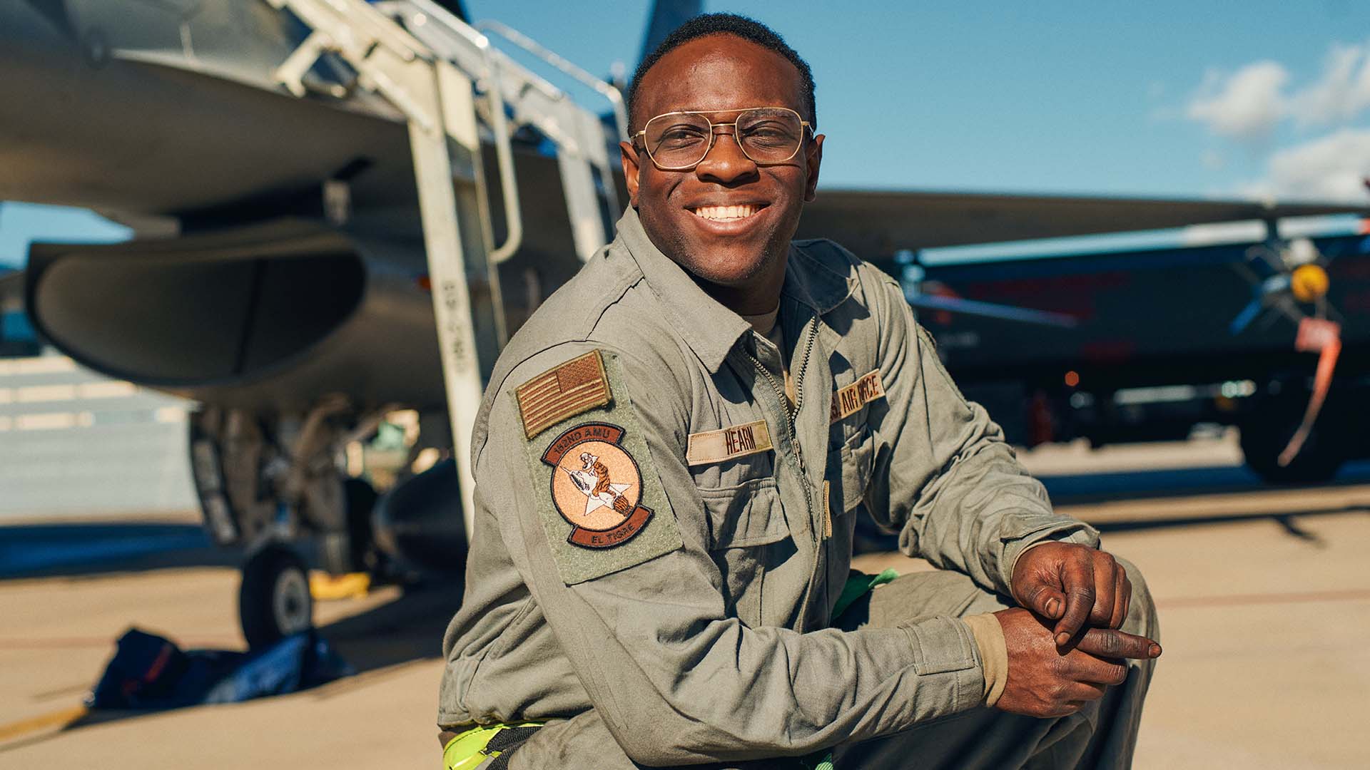 Staff Sergeant Daviyd “Rex” Hearn in front of a jet.