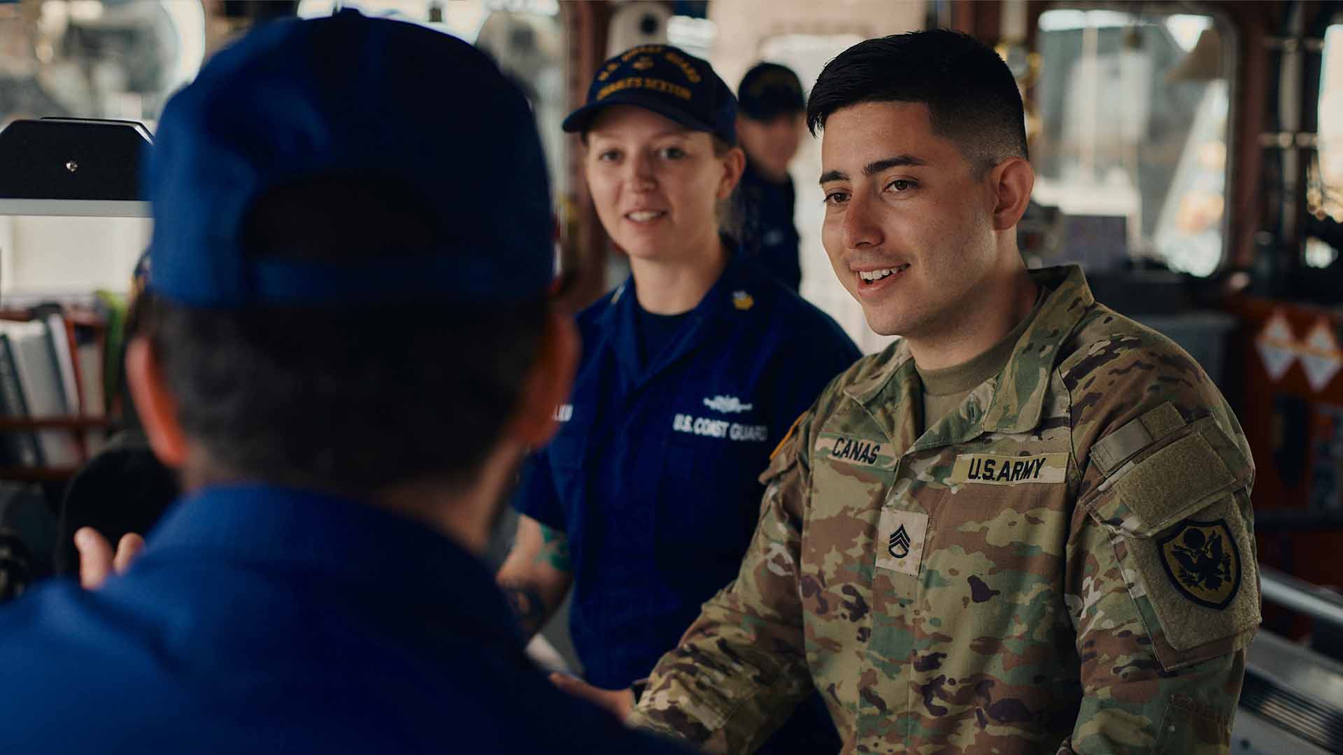 Juan Canas, talking with fellow service members