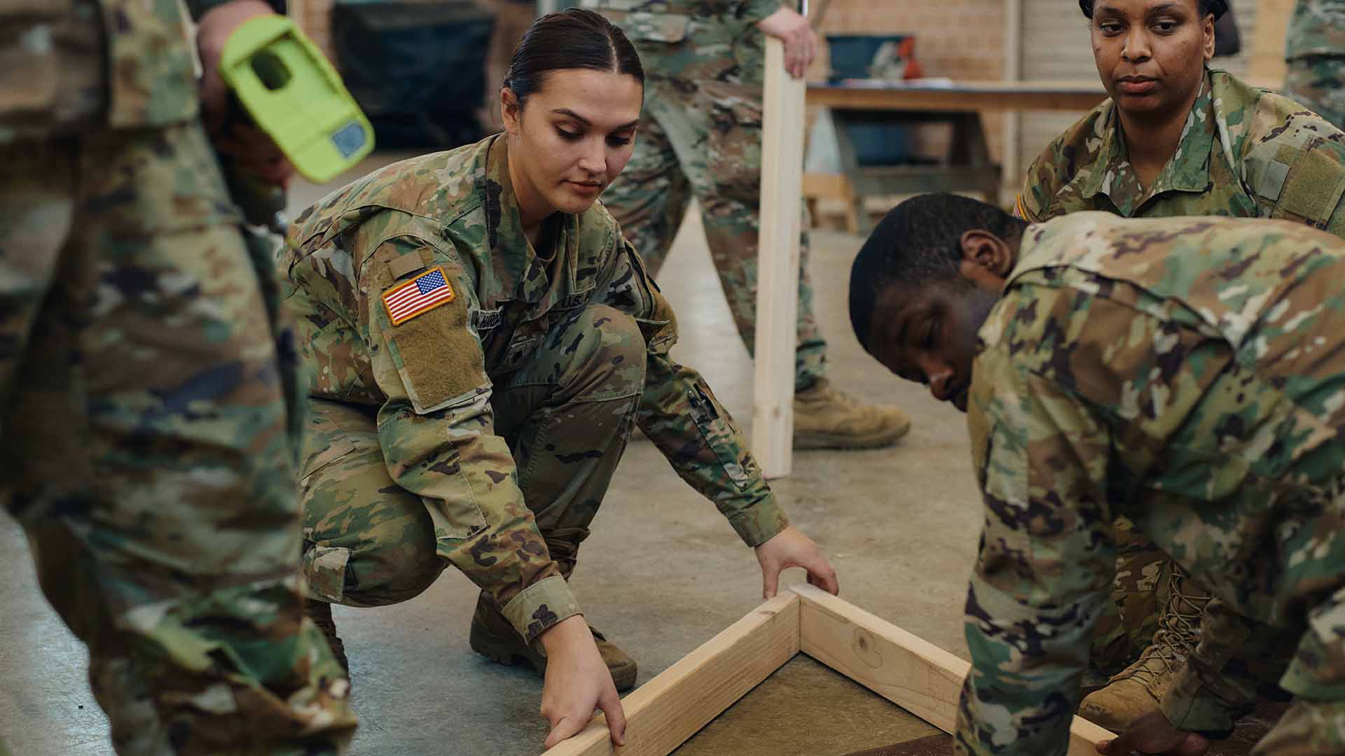 Rebekah working on a frame with service members