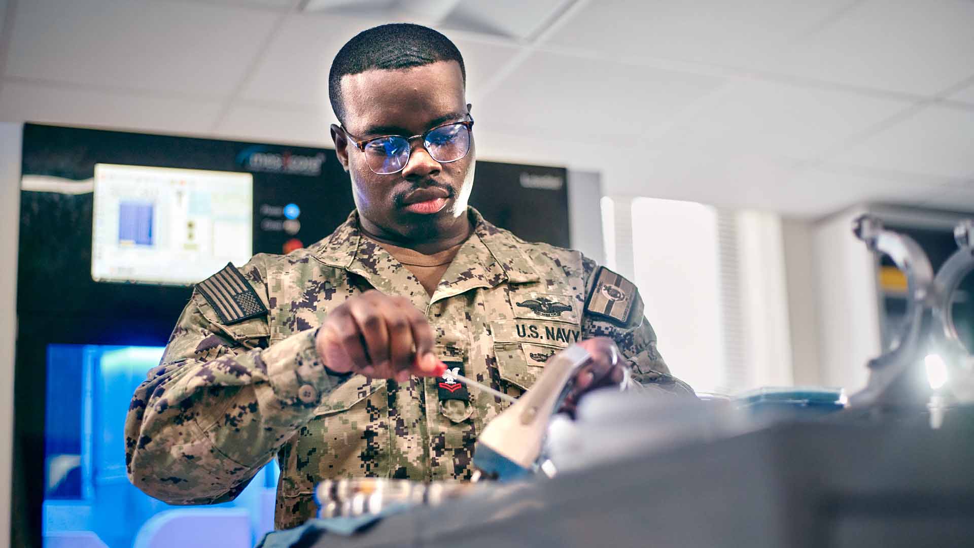 Ofori Barnaby Jr. ("Barnaby") working with tools in a dental lab