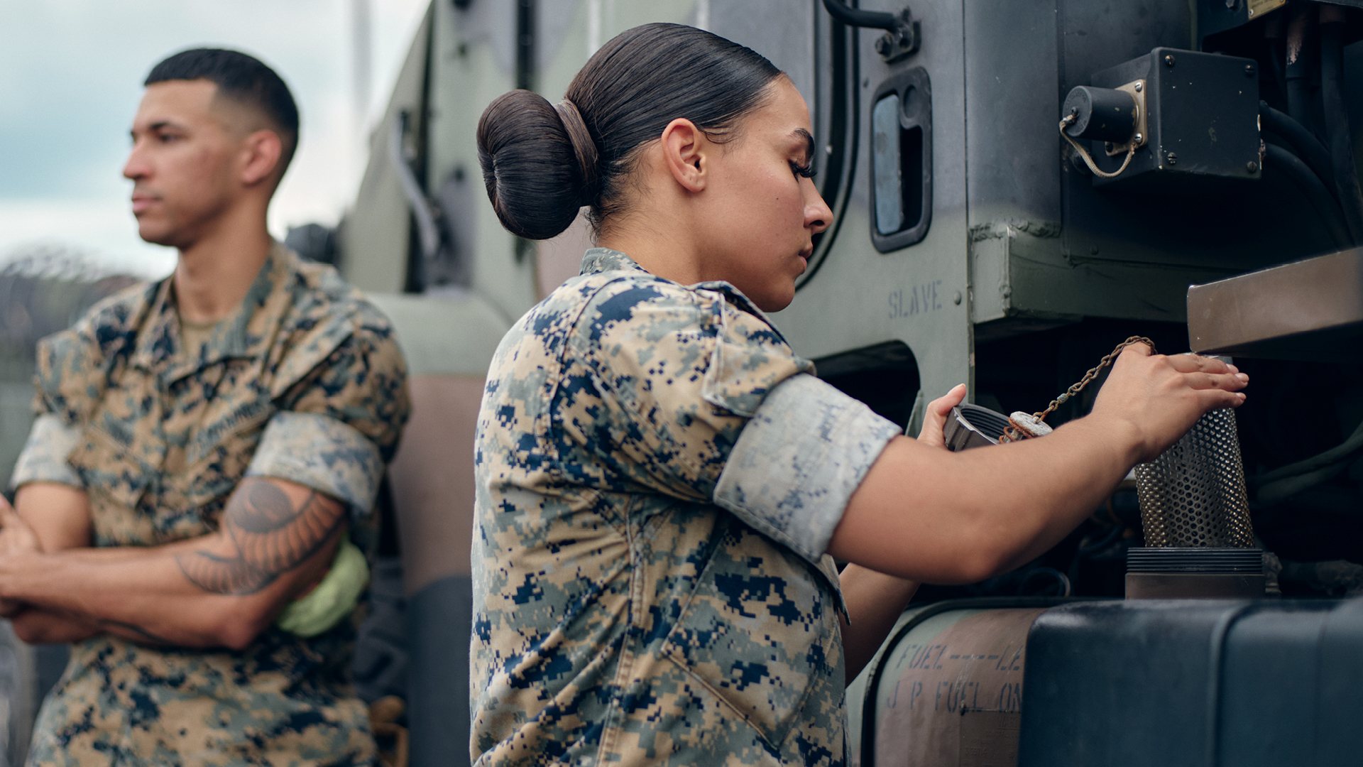 Kendyl Smith checking the fuel tank of a tactical truck.