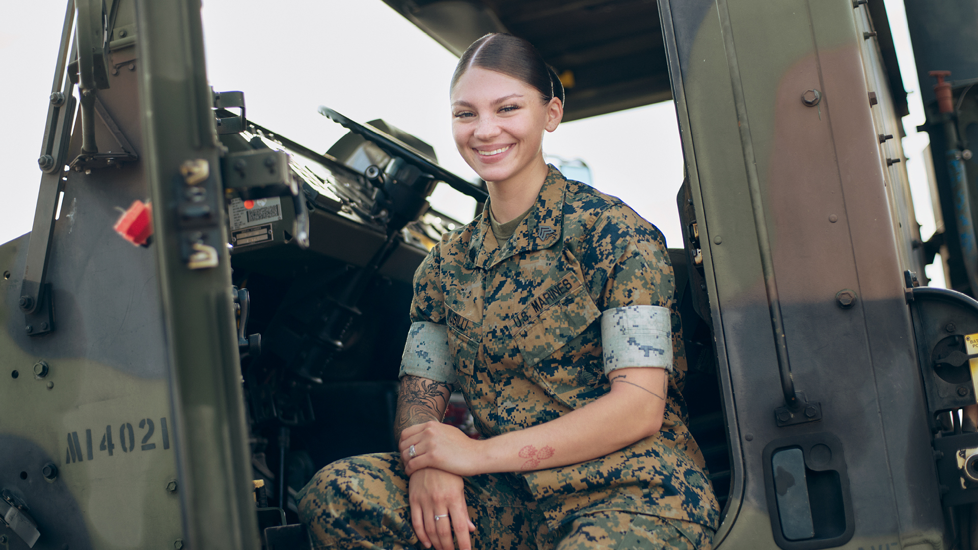 Mackenzie Musilli sitting in a tactical truck.