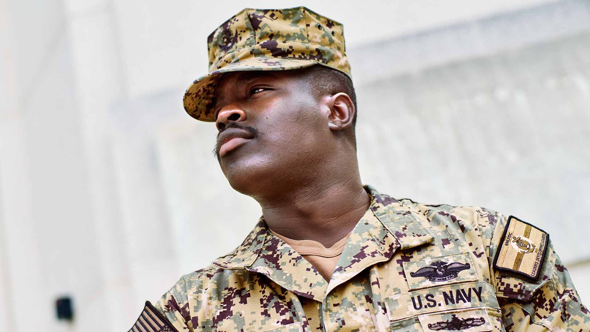 Ofori Barnaby Jr. ("Barnaby") looking into distance in front of a building