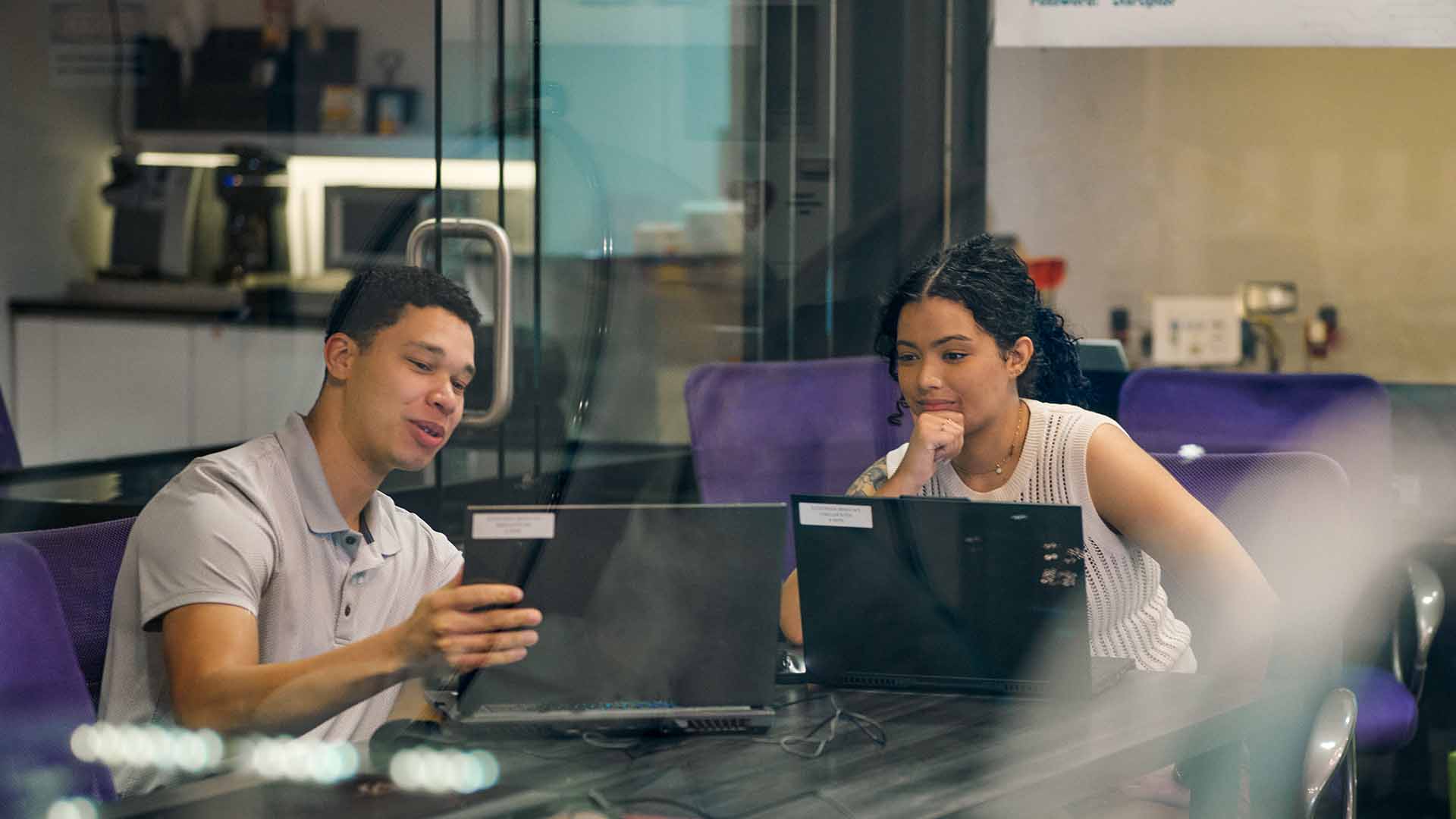 Kyla Bruno working directly with another coworker.