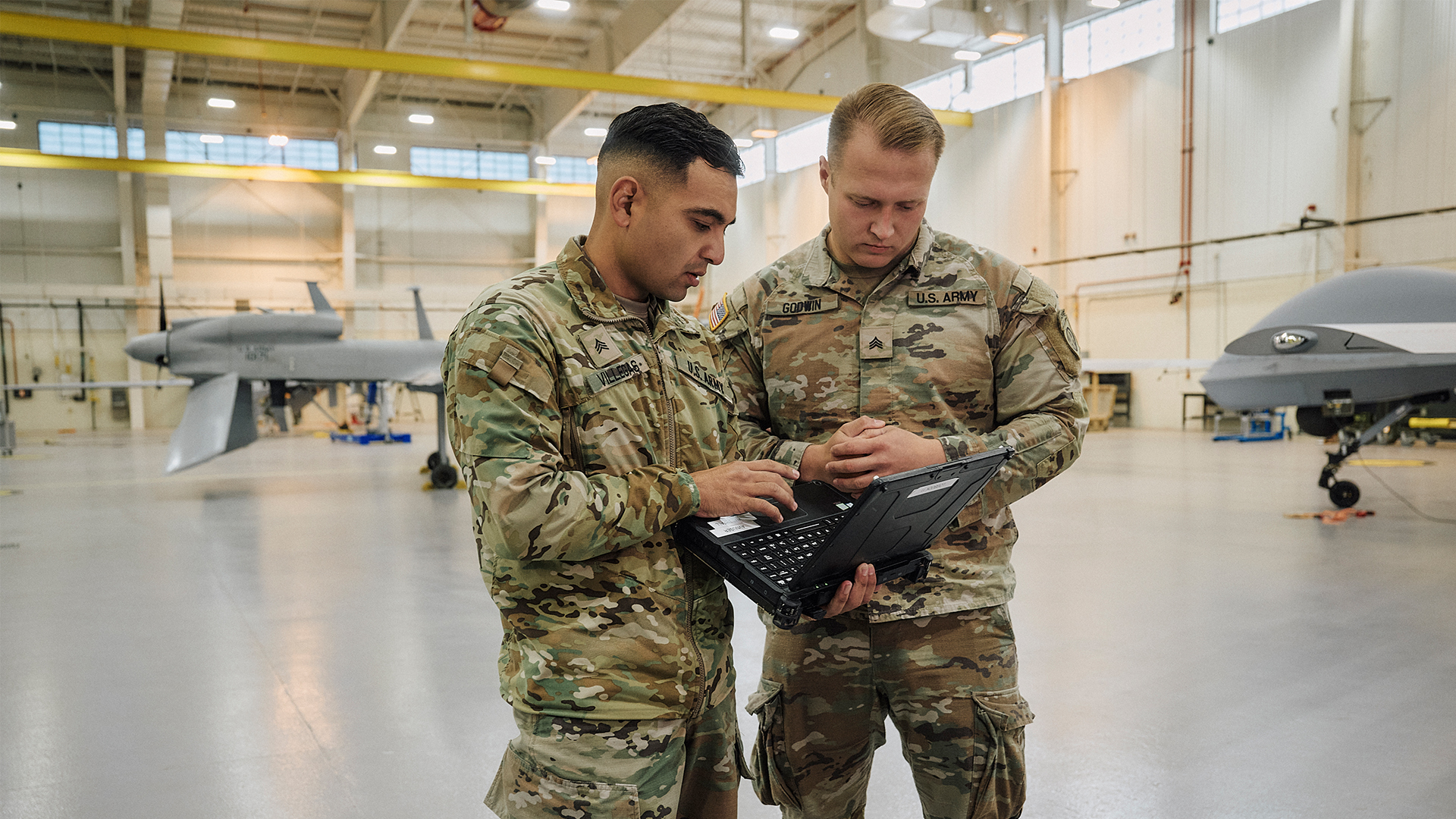 Luis Villegas working with another service member